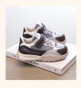 Detailed view of stylish blue and grey children's sneakers with chunky non-slip soles.