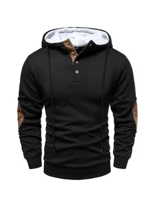 Detail view of men's heavy black textured hoodie with brown elbow patches and white lining