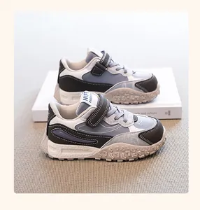 Close-up of stylish kids' chunky sneakers with durable textured sole and velcro straps