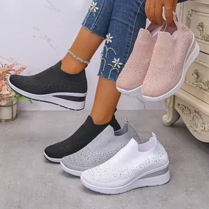 Vista dettagliata delle sneaker con zeppa in maglia e strass nero, bianco, grigio e rosa