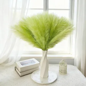 Nordic style faux green pampas grass in white ceramic vase for home and wedding decor