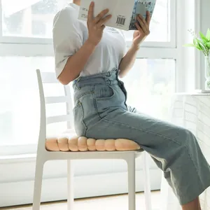 Soft biscuit-shaped plush chair cushion providing comfortable seating in home or office
