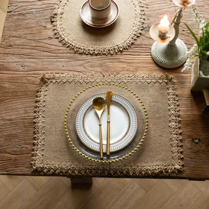 Close-up of a rustic jute placemat with elegant lace trim on a vintage wooden table
