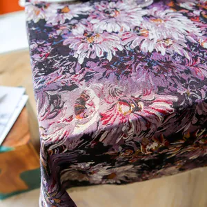 Close-up of high-density thick purple floral woven tablecloth showing fabric texture
