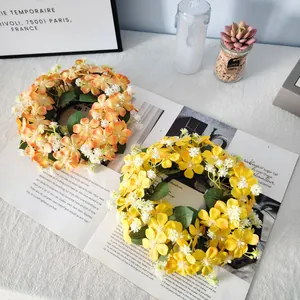 Detailed view of two vibrant artificial wildflower candle ring wreaths for home decor