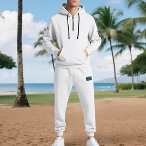 Men's white fleece tracksuit set with half-zip hoodie and cargo sweatpants on beach
