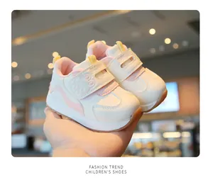 Close-up view of premium breathable soft-sole toddler sneakers in white and pink