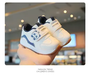 Detailed view of white baby walker shoes with cute panda design and velcro strap