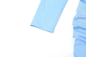 Close-up detail of light blue long sleeve cuff and pleated fabric texture on a slim fit dress.