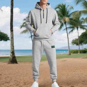 Full-length view of a men's heavy gray hoodie and sweatpants set on a beach