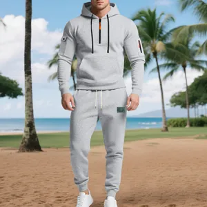 Full view of grey heavyweight fleece hoodie and jogger tracksuit set on tropical beach.