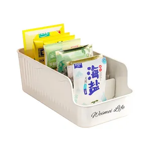 White plastic seasoning packet organizer box for efficient kitchen cabinet storage