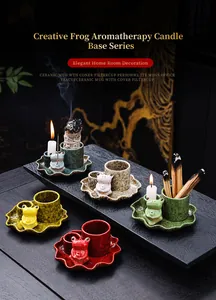 Detailed view of colorful ceramic frog incense holders with palo santo and candles