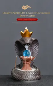 Detailed view of creative cobra purple clay backflow incense burner with golden crown