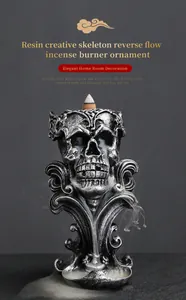 Detailed close-up of a silver skeleton backflow incense burner with mystical smoke effect