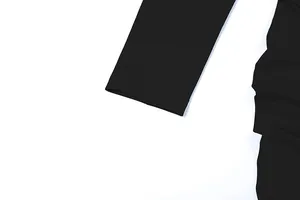 Macro detail of the sleeve cuff stitching and ruching on a black slim fit dress