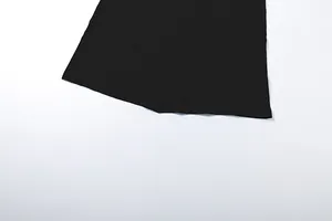 Detailed close-up showing the bottom hem of a elegant black solid color maxi dress.
