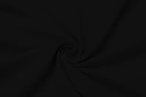 Close-up texture detail of elegant black pleated fabric for autumn slim-fit dress