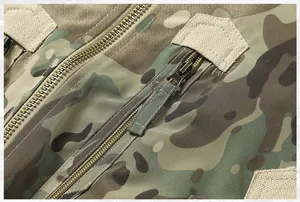 Close-up detail shot of the durable metal zipper on a camouflage tactical flight jacket