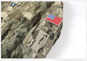 Detail of camouflage tactical flight jacket with American flag patch on arm pocket