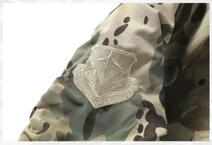 Close-up detail of embroidered army team patch on camouflage flight jacket sleeve