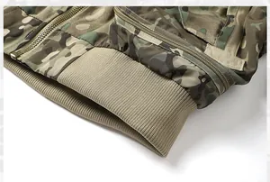 Close-up of a tactical camouflage bomber jacket with ribbed hem and metal zipper