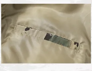 Close-up macro view of internal pocket on flight bomber jacket with camouflage trim detail