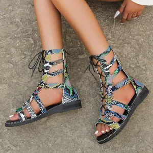 Close-up detail of colorful snakeskin-patterned gladiator sandals with back zipper.