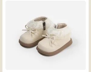 Detailed view of cream toddler girl princess boots featuring lace trim and bow decor
