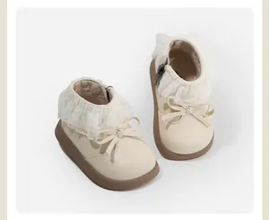 Elegant toddler girl cream leather boots featuring delicate lace trim and sweet bow detail