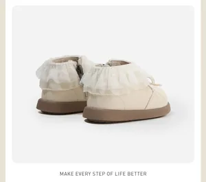 Detailed back view of cream toddler girl ankle boots with delicate white lace ruffles