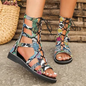 Detailed view of colorful snake-print gladiator sandals with lace-up design.