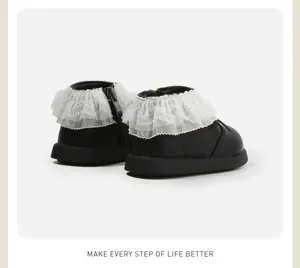 Detailed rear view of black toddler boots with delicate white lace ruffle and side zipper