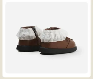Detail view of brown toddler boots with white lace ruffle collar and side zipper