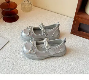 Detailed view of silver girls' princess shoes showing bow and pearl rhinestone strap