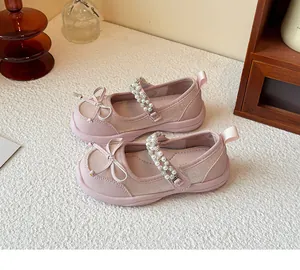Detail of pink girls princess shoes featuring double pearl straps and bow decorations