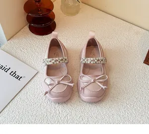 Detailed view of pink girls' princess shoes with bow and pearl rhinestones