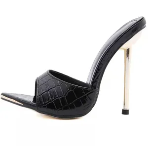Black crocodile-embossed mule with thin metallic gold stiletto heel and pointed toe.