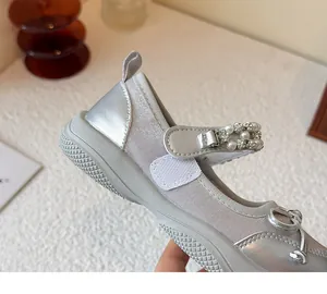 Close-up detail of silver girls princess shoe featuring rhinestone strap and a sporty sole