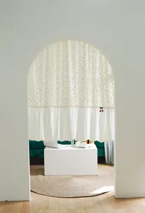 White cotton partition curtain with cherry accent in arched doorway decor