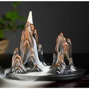Macro detail of white smoke cascading down a resin mountain backflow incense burner