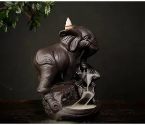 Detailed view of a purple sand elephant backflow incense burner with thick flowing smoke