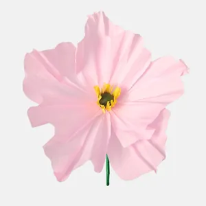Detailed close-up of a large handmade pink crepe paper poppy flower for decoration