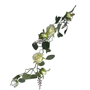 Detailed view of realistic white French roses and green eucalyptus leaves on a decorative vine