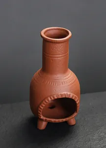 Detail view of rustic brown ceramic mini fireplace incense burner with textured finish