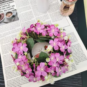 Detail shot of a pink and white wild flower wreath on vintage newspaper background