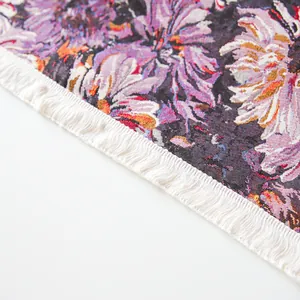 Close-up detail of purple floral yarn-dyed tablecloth with elegant white fringe tassels