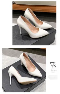 Elegant white patent leather pointed-toe pumps with high thin heels on display box
