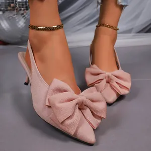 Elegant pink pointed-toe slingback high heels featuring a large decorative bow.