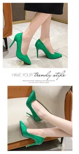 Close-up detail of vibrant green patent leather pointed-toe stiletto high heels